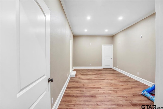 interior space with crown molding, recessed lighting, baseboards, and light wood-type flooring