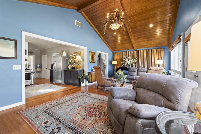 living area with hardwood / wood-style floors, a chandelier, wood ceiling, beam ceiling, and visible vents