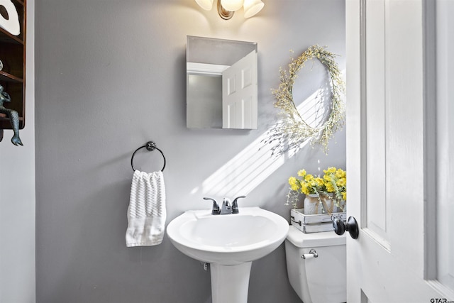 bathroom with toilet and a sink