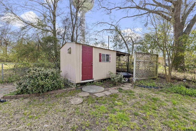 view of shed featuring fence