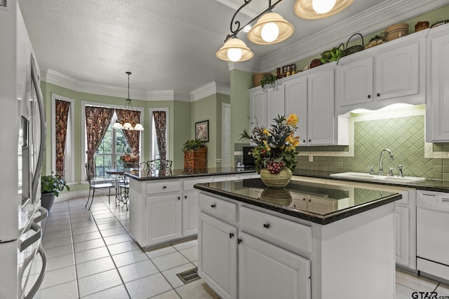 kitchen featuring a center island, stainless steel fridge, pendant lighting, and white dishwasher