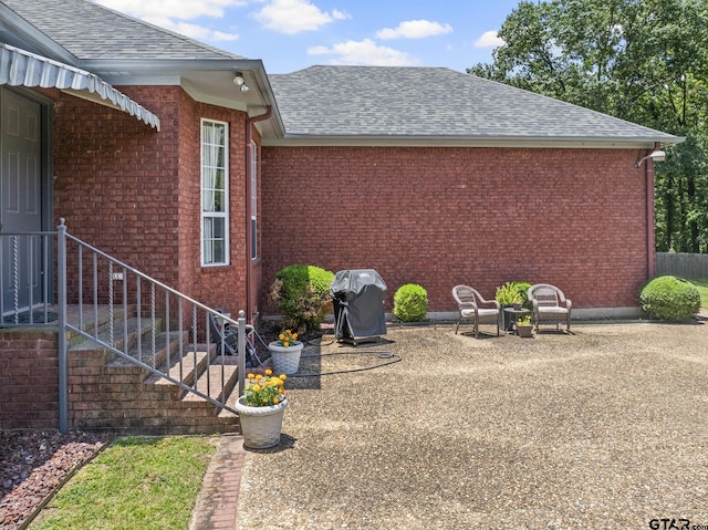 view of side of home with a patio