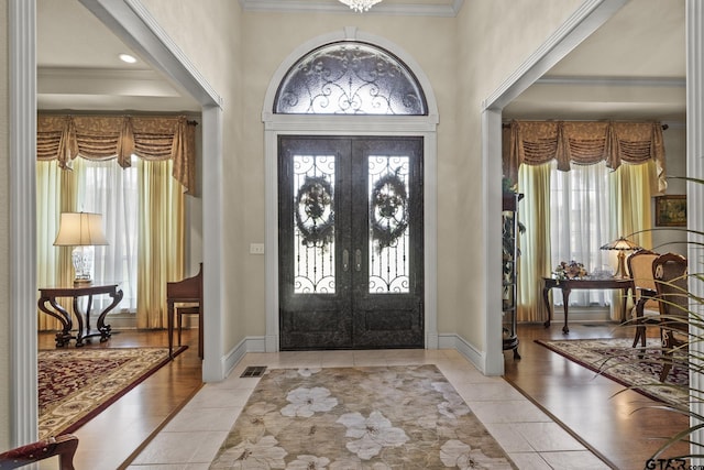 foyer entrance featuring light tile patterned floors and plenty of natural light