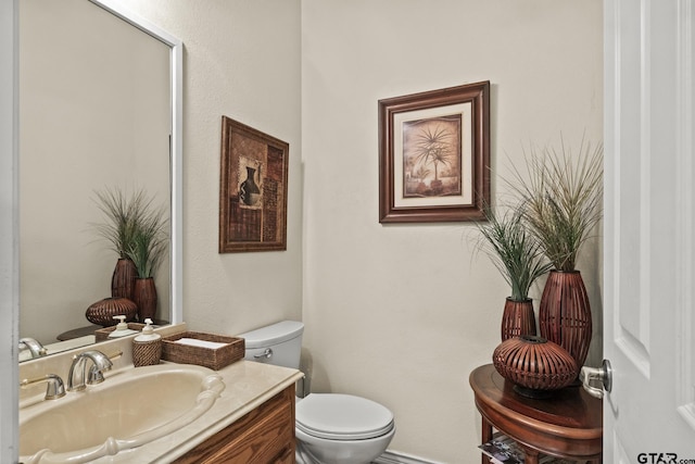 bathroom featuring toilet and vanity