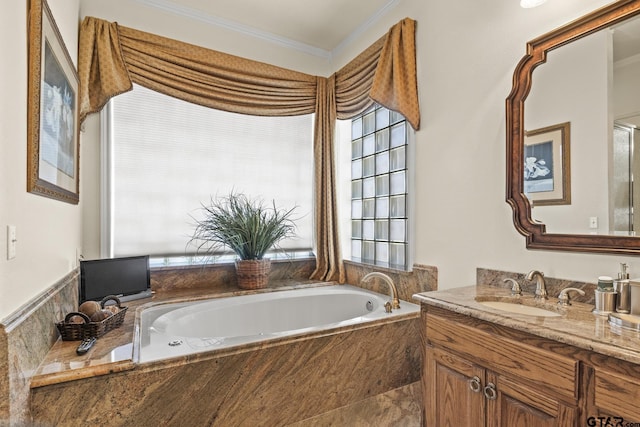 bathroom featuring vanity, tiled tub, and crown molding