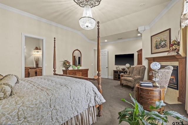 carpeted bedroom with a chandelier, vaulted ceiling, ensuite bathroom, a tile fireplace, and crown molding