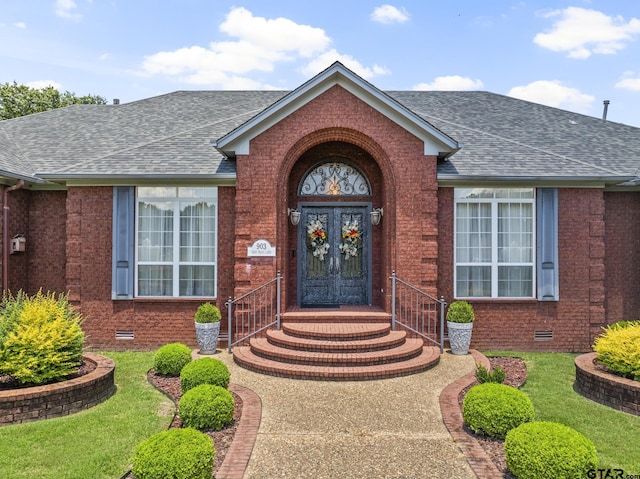 property entrance with french doors and a yard