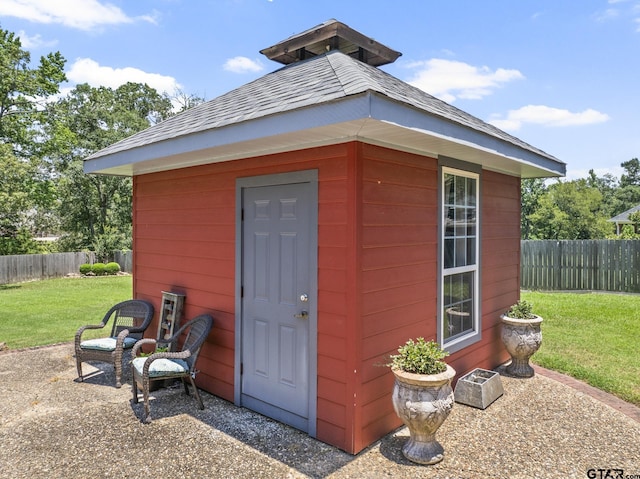 view of outbuilding featuring a lawn