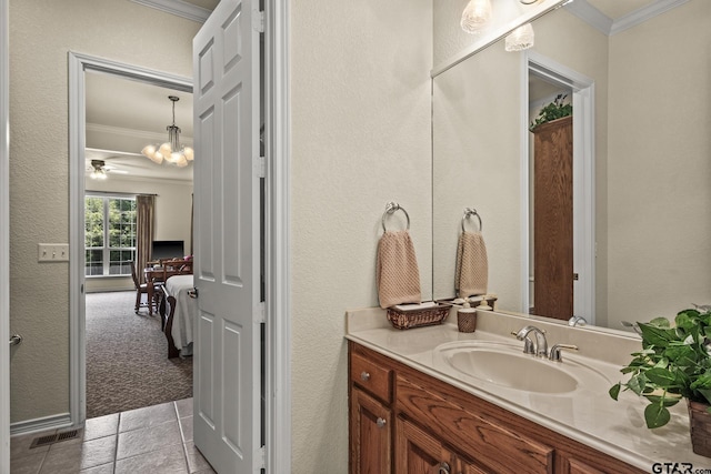 bathroom with vanity, ornamental molding, and tile patterned flooring