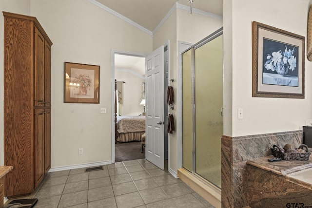 bathroom with tile patterned floors, a shower with shower door, ornamental molding, and lofted ceiling