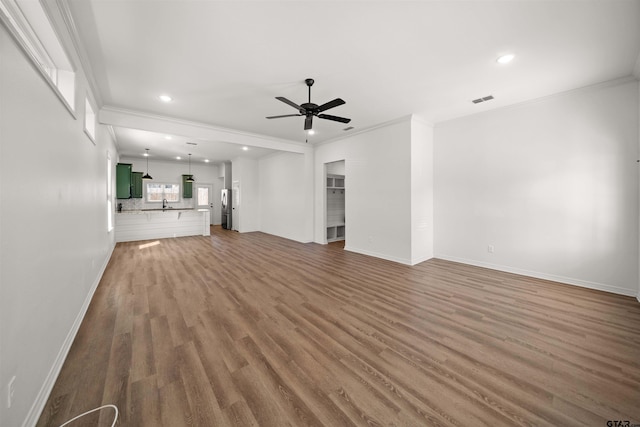 2716 Royal Village Way, Tyler, TX 75701 - unfurnished living room featuring a ceiling fan, wood finished floors, ornamental molding, baseboards, and recessed lighting