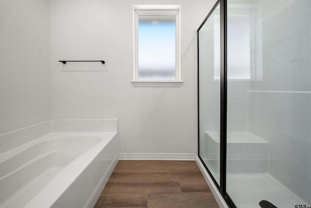 2716 Royal Village Way, Tyler, TX 75701 - full bathroom featuring wood finished floors, a shower stall, baseboards, and a bath