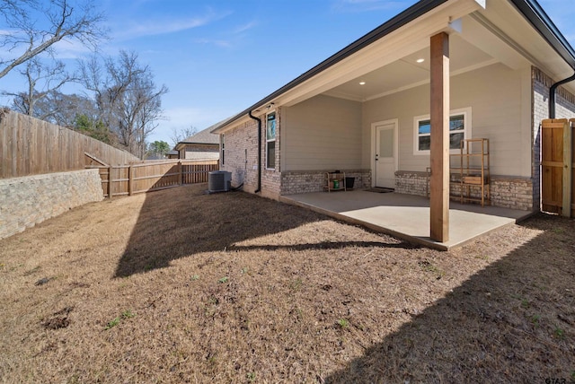 2716 Royal Village Way, Tyler, TX 75701 - back of property with central AC, a patio area, a fenced backyard, and brick siding