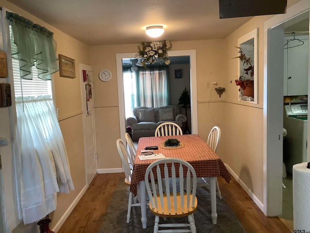 dining room featuring hardwood / wood-style flooring, plenty of natural light, and washer / clothes dryer