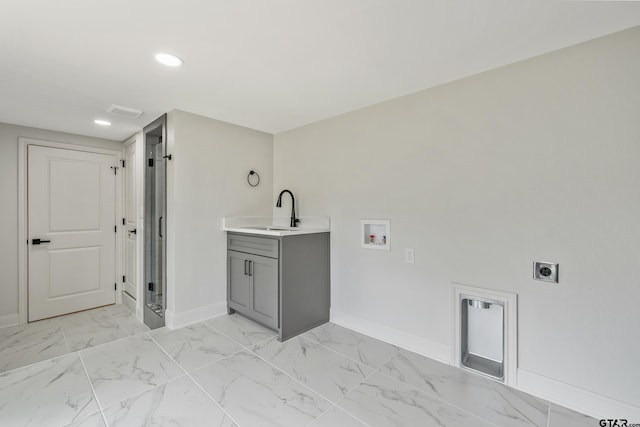 2918 Oak Knob Dr, Tyler, TX 75701 - laundry room featuring hookup for an electric dryer, a sink, baseboards, hookup for a washing machine, and recessed lighting