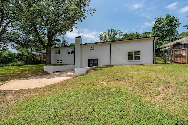 2918 Oak Knob Dr, Tyler, TX 75701 - back of house with a chimney and a yard