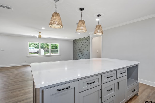 2918 Oak Knob Dr, Tyler, TX 75701 - kitchen featuring wood finished floors, ornamental molding, light countertops, pendant lighting, and recessed lighting