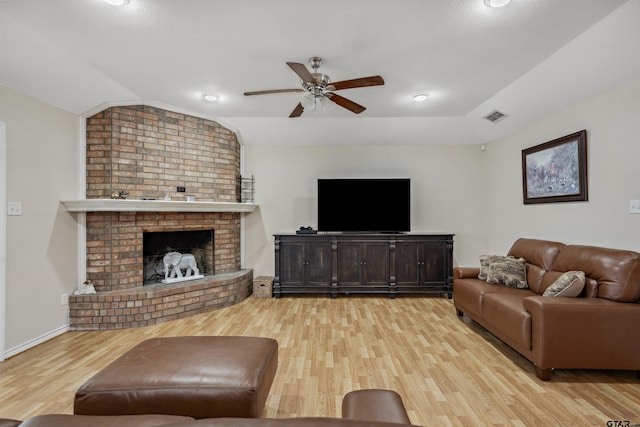 1039 Fm 2909, Canton, TX 75103 - living room with lofted ceiling, light wood-style flooring, a ceiling fan, a brick fireplace, and baseboards