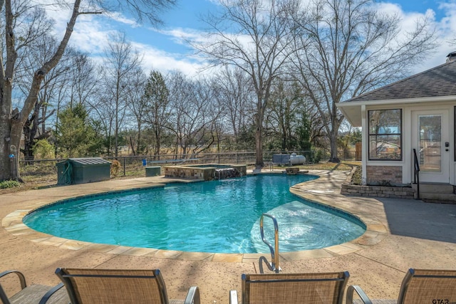 view of swimming pool featuring a pool with connected hot tub, a fenced backyard, and a patio area