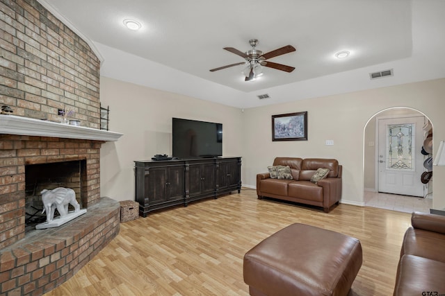 1039 Fm 2909, Canton, TX 75103 - living area with light wood-style floors, a ceiling fan, arched walkways, a brick fireplace, and baseboards