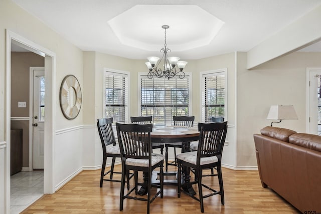 1039 Fm 2909, Canton, TX 75103 - dining room featuring light wood-style floors, a chandelier, a raised ceiling, and baseboards