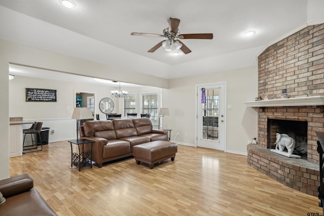 1039 Fm 2909, Canton, TX 75103 - living room with ceiling fan, light wood finished floors, a chandelier, a fireplace, and baseboards
