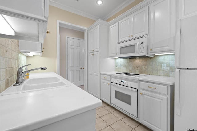 kitchen featuring crown molding, light tile patterned floors, white cabinetry, a sink, and white appliances