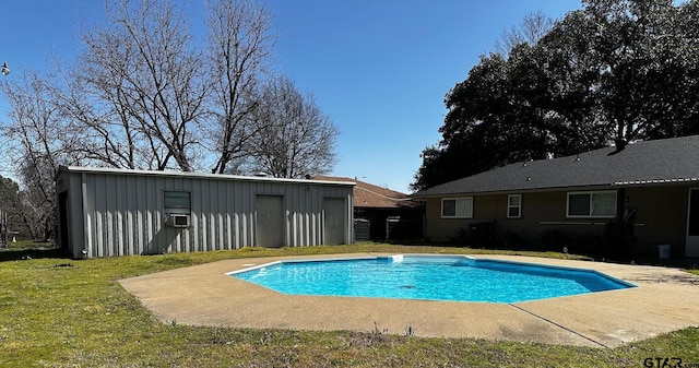 pool featuring cooling unit, an outbuilding, and a lawn