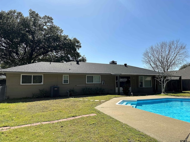 view of swimming pool with a yard, a fenced in pool, and central AC