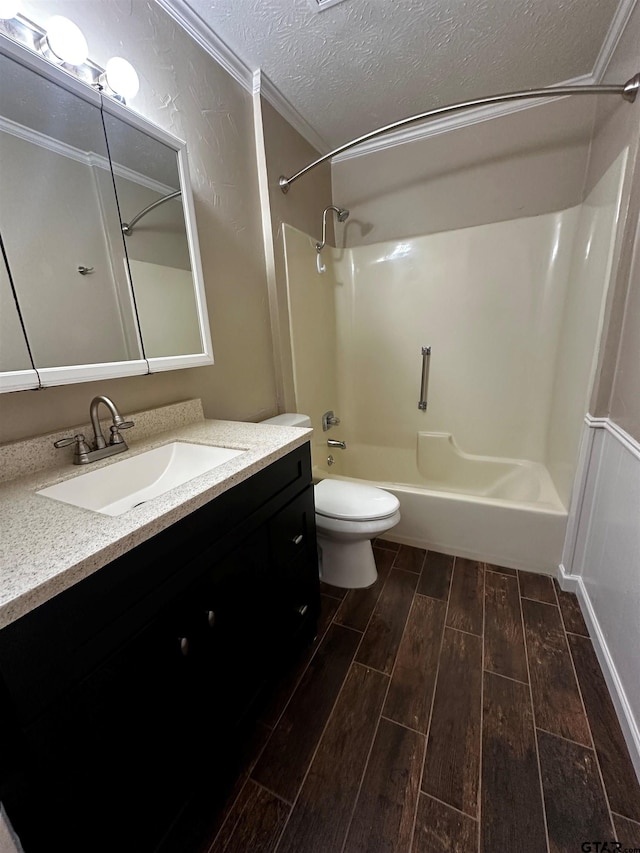 bathroom with vanity, wood tiled floor, a textured ceiling, bathing tub / shower combination, and toilet