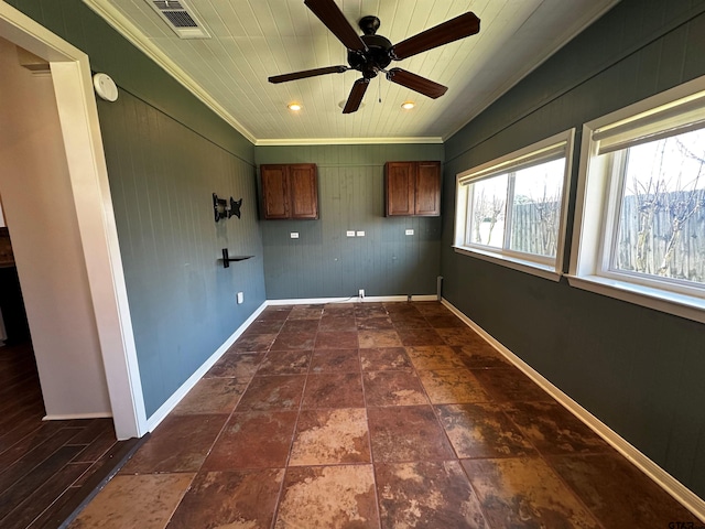 clothes washing area with visible vents, a ceiling fan, crown molding, baseboards, and wood ceiling