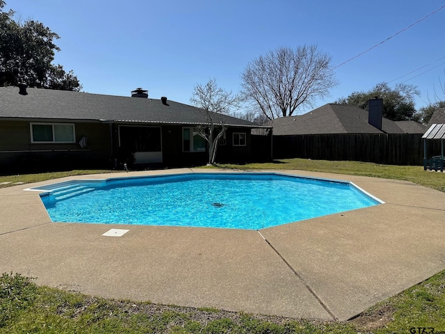 view of swimming pool with a patio area, a fenced in pool, a yard, and fence