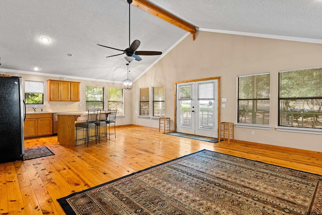 149 Primrose Path, Hawkins, TX 75765 - living area with light wood-type flooring, a textured ceiling, ceiling fan, beam ceiling, and french doors