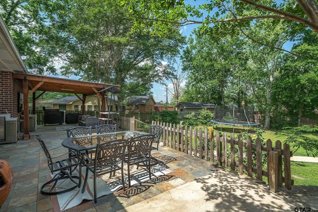 1807 Mill Creek Rd, Canton, TX 75103 - view of patio with a trampoline, outdoor dining space, and central AC unit