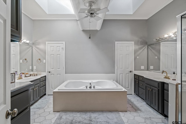 1807 Mill Creek Rd, Canton, TX 75103 - bathroom with ceiling fan, a bath, tile patterned floors, a skylight, and two vanities