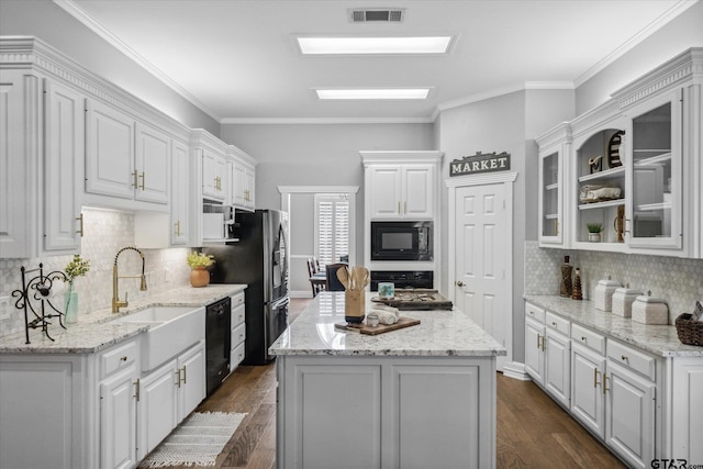 1807 Mill Creek Rd, Canton, TX 75103 - kitchen featuring black appliances, white cabinetry, a sink, dark wood-type flooring, and a kitchen island