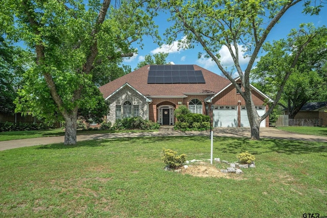 1807 Mill Creek Rd, Canton, TX 75103 - view of front facade with concrete driveway, a front lawn, solar panels, brick siding, and a shingled roof