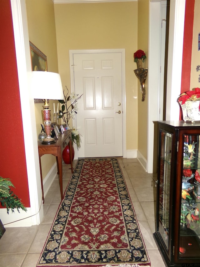 entryway with baseboards and light tile patterned flooring