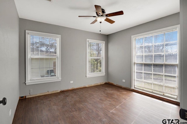 unfurnished room featuring dark wood-style flooring and ceiling fan