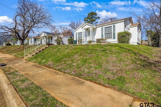 single story home with a front lawn