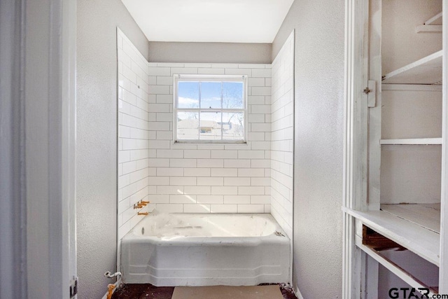 full bathroom featuring a textured wall