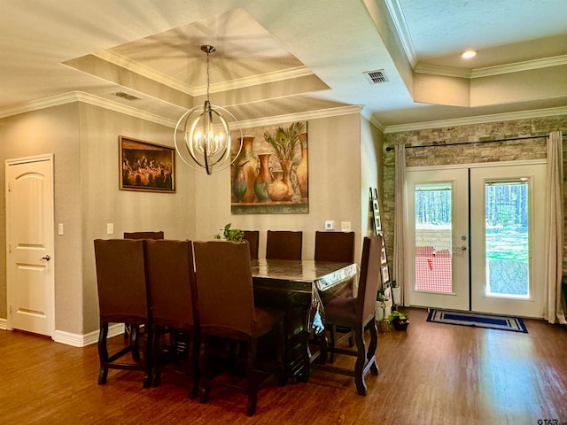 dining room with french doors, ornamental molding, a notable chandelier, dark hardwood / wood-style flooring, and a tray ceiling