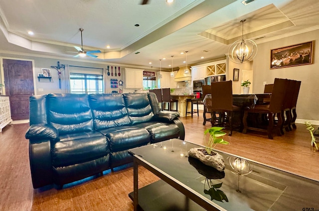 living room featuring light hardwood / wood-style flooring and a raised ceiling