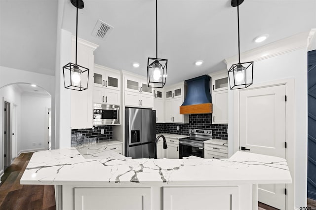 kitchen with premium range hood, white cabinetry, decorative light fixtures, stainless steel appliances, and light stone countertops