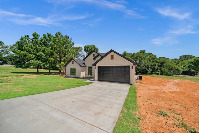 view of front of house with a garage and a front yard