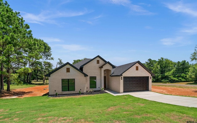 view of front of property with a garage and a front yard