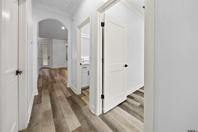 corridor with ornamental molding and dark hardwood / wood-style floors