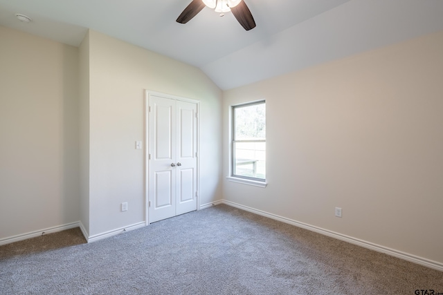 unfurnished room with carpet floors, ceiling fan, and lofted ceiling