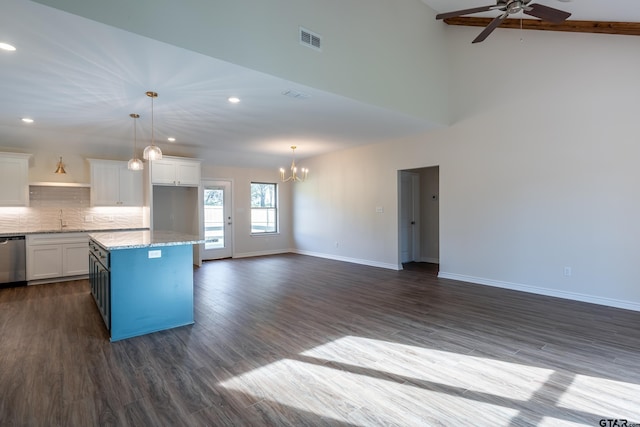 kitchen featuring white cabinets, ceiling fan with notable chandelier, a center island, and dark hardwood / wood-style flooring