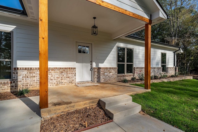 view of exterior entry featuring a yard